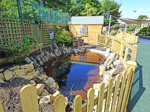 Nature observation pond with wooden safety fencing