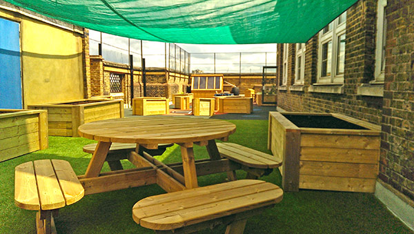 School roof area transformed with seating and planters